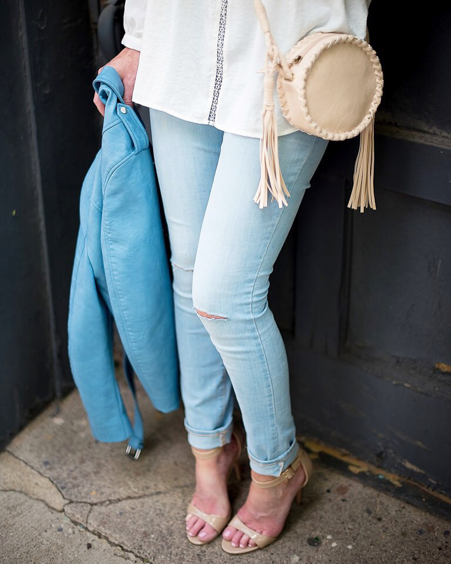 white-eyelet-blouse-light-wash-skinny-jeans-diy-jean rips-blue-zara-cropped-faux-leather-moto-jacket-tassel-canteen-bag