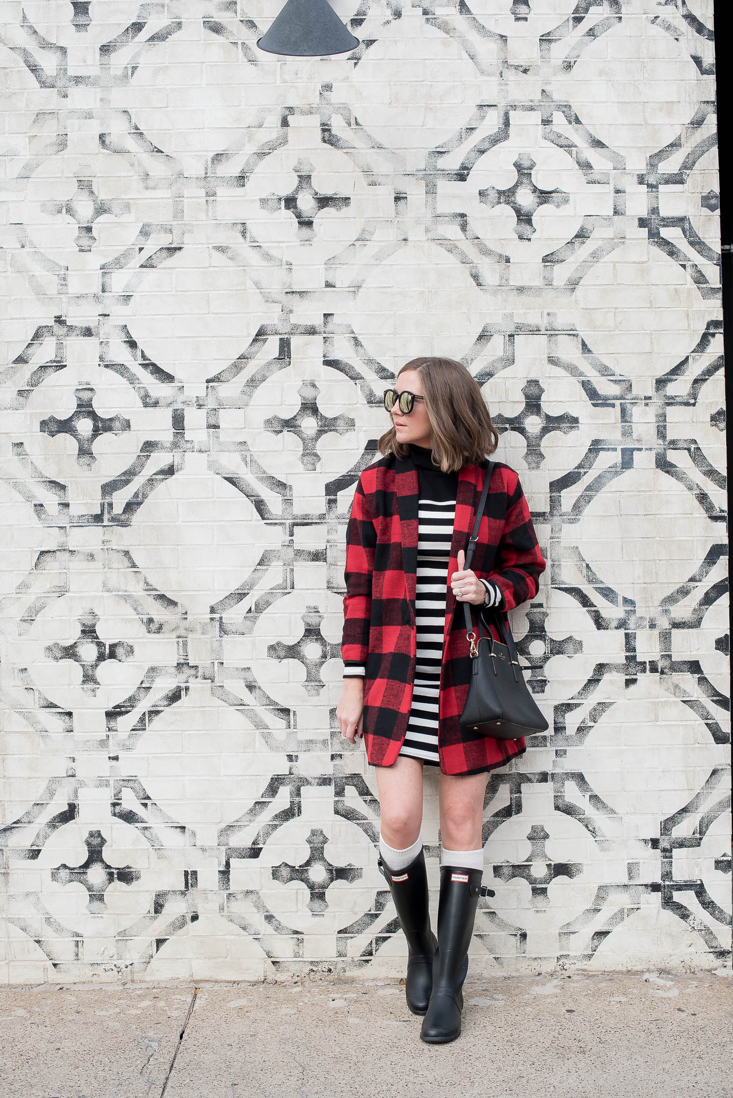 black-and-white-striped-mini-dress-and-red-buffalo-plaid-coat-with-hunter-boots-the-perfect-blogger-wall-for-photos-dowtown-chicago-mild-winter-outfit