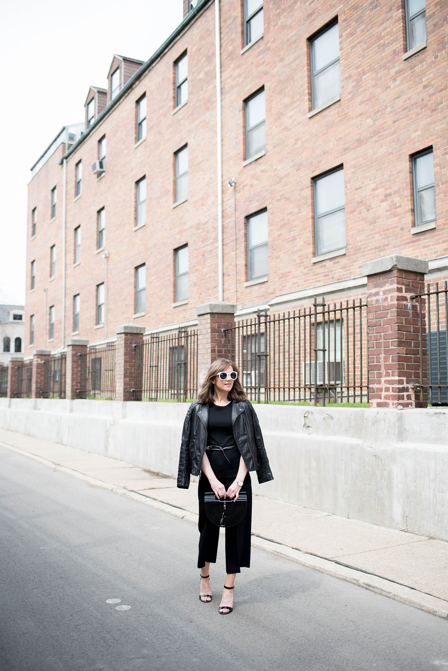 how to style black crop pants, culotte outfit idea, edgy spring outfit, black cult gaia arc clutch, the studded skinny belt, monochromatic outfit